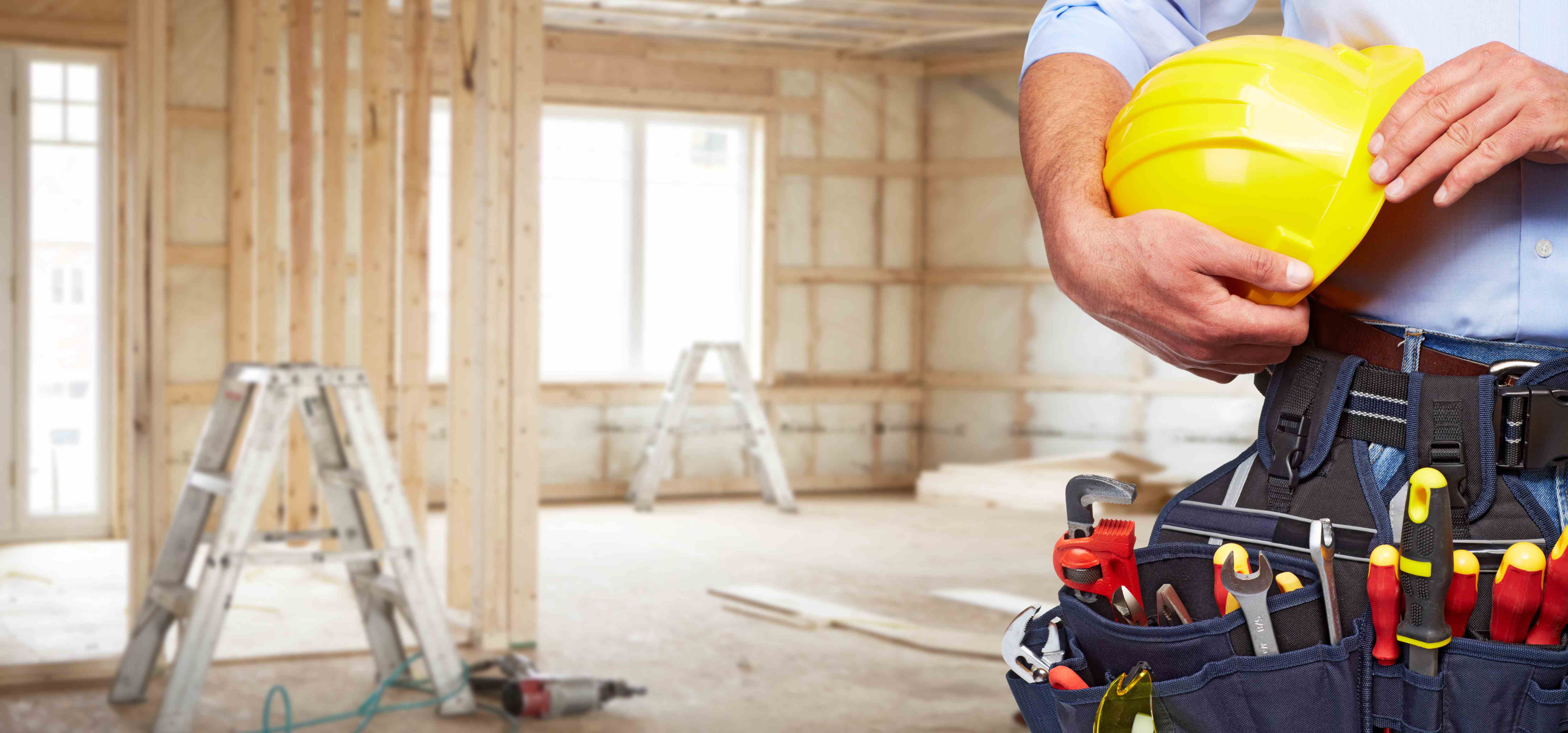 Builder handyman with tools and bone remodeling on the background