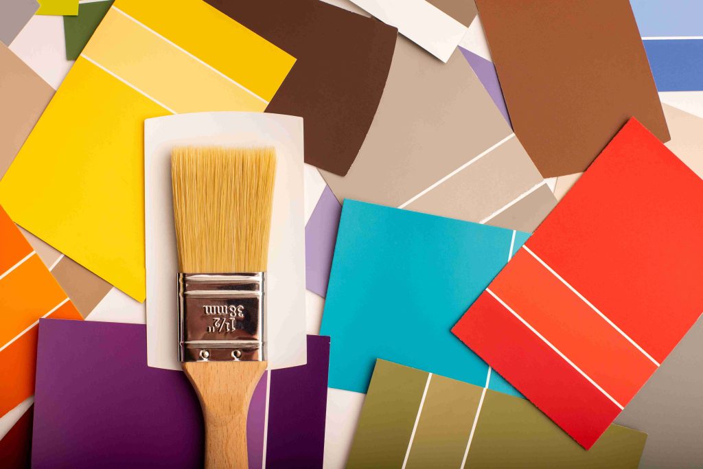 A brush is lying on a diverse color palette from the bathroom catalog